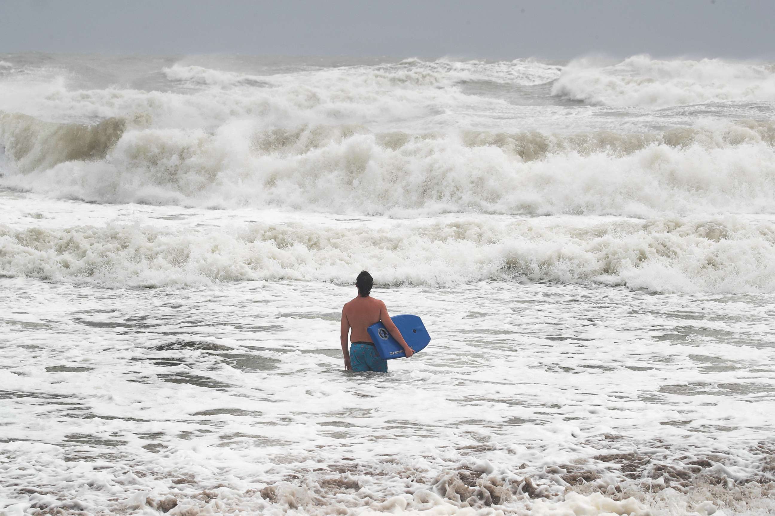 PHOTO: A swimmer takes advantage of big waves during high tide as Hurricane Dorian churns offshore on September 3, 2019, in Indialantic, Fla.