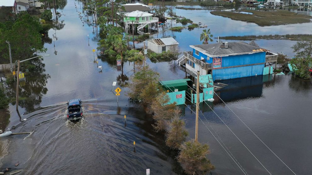 PHOTO: An aerial view shows a vehicle driving through a flooded street after Hurricane Sally passed through the area, Sept. 17, 2020, in Gulf Shores, Ala. 