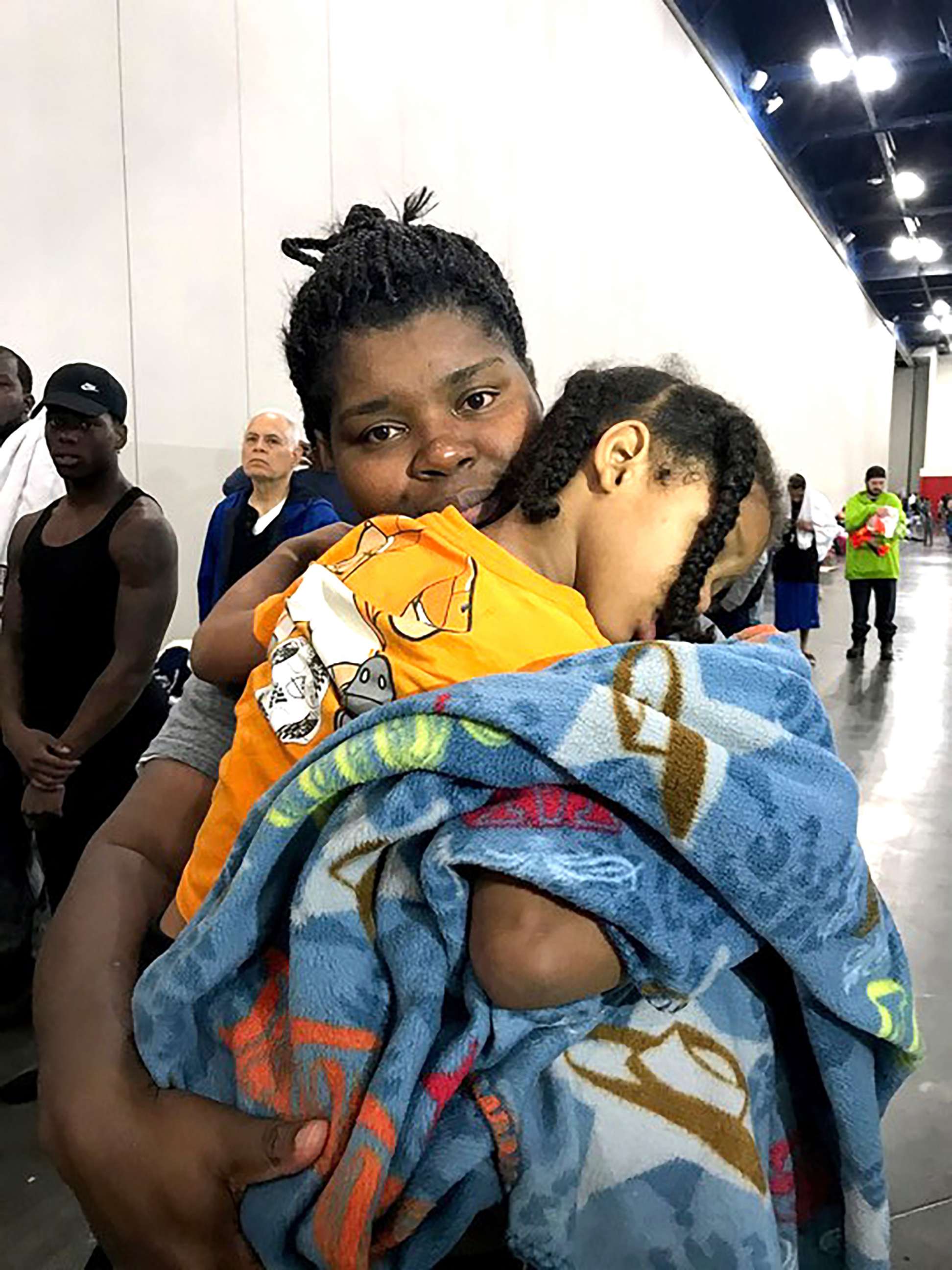 PHOTO: Iashia Nelson embraces her son after they were rescued from the rooftop of a downtown Houston apartment building where they were stranded following Hurricane Harvey. 
