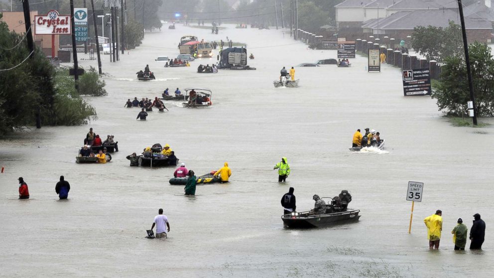 Rescue boats fill a flooded street at flood victims are evacuated as floodwaters from Harvey rise, Aug. 28, 2017, in Houston. 