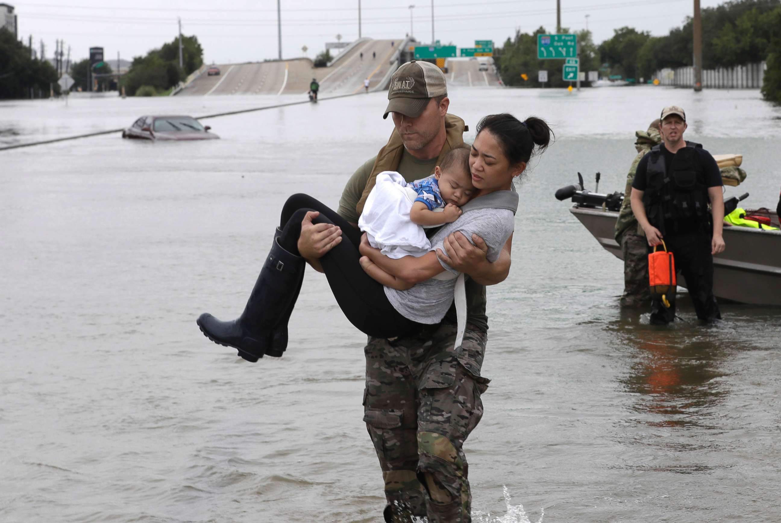 PHOTO: Houston Police SWAT officer Daryl Hudeck carries Catherine Pham and her 13-month-old son Aiden after rescuing them from their home surrounded by floodwaters from Tropical Storm Harvey, Aug. 27, 2017, in Houston. 
