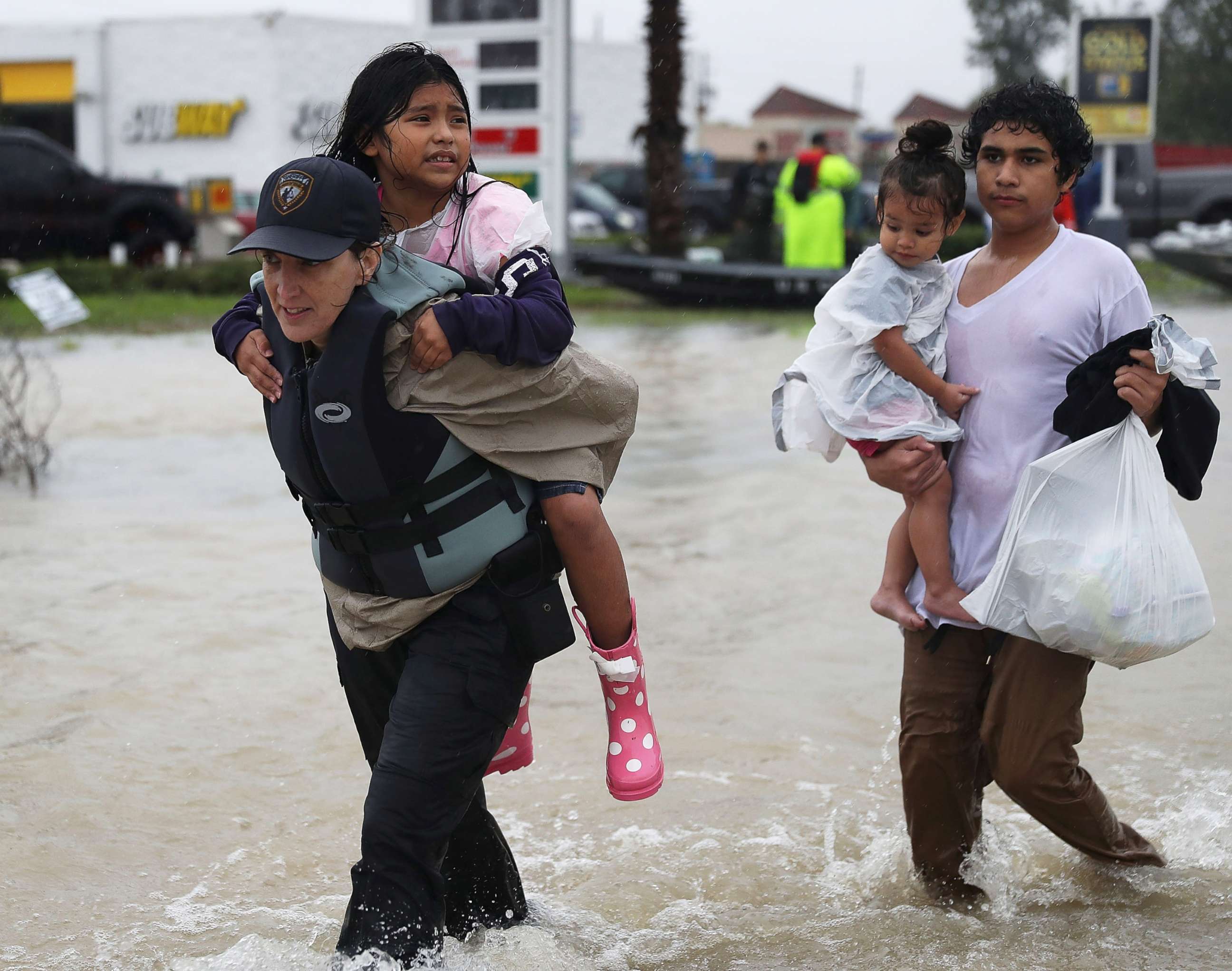PHOTO: Evacuees are helped to dry land after their homes were inundated with flooding from Hurricane Harvey, Aug. 28, 2017 in Houston. 