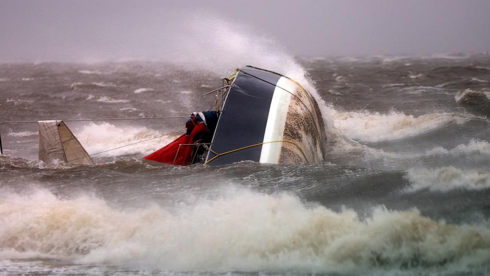 PHOTO: A capsized boat washes ashore as Hurricane Helene churns offshore on Sept. 26, 2024, in St. Petersburg, Fla.