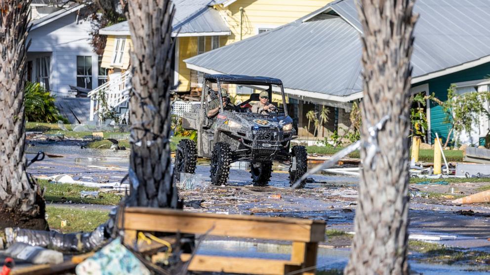 PHOTO: Officers drive through rubbles left behind by Hurricane Helene in Cedar Key, Fla., Sept. 27, 2024. 