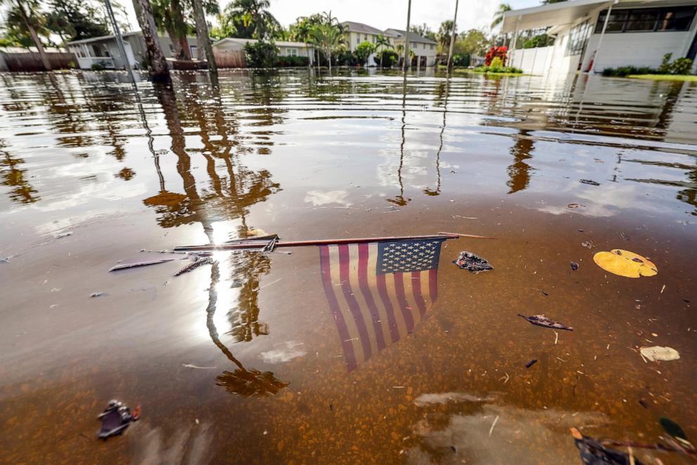 PHOTO: An American flag sits in the floodwaters from Hurricane Helene in the Shore Acres neighborhood, Sept. 27, 2024, in St. Petersburg, Fla. 