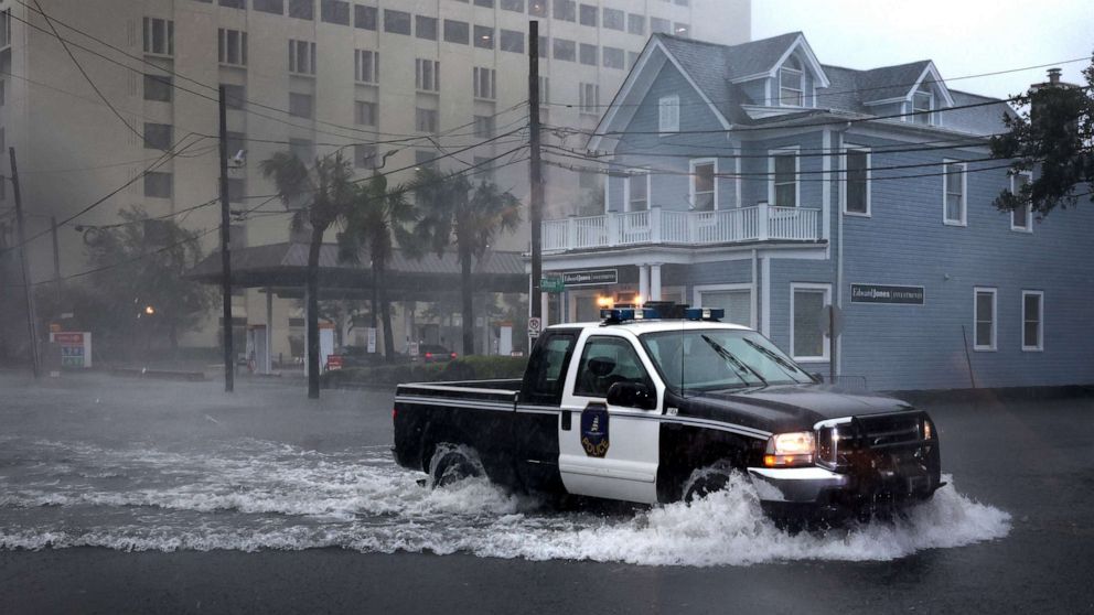 PHOTO: A police vehicle drives down a flooded street as rain from Hurricane Ian drenches the city, Sept. 30, 2022 in Charleston, South Carolina.