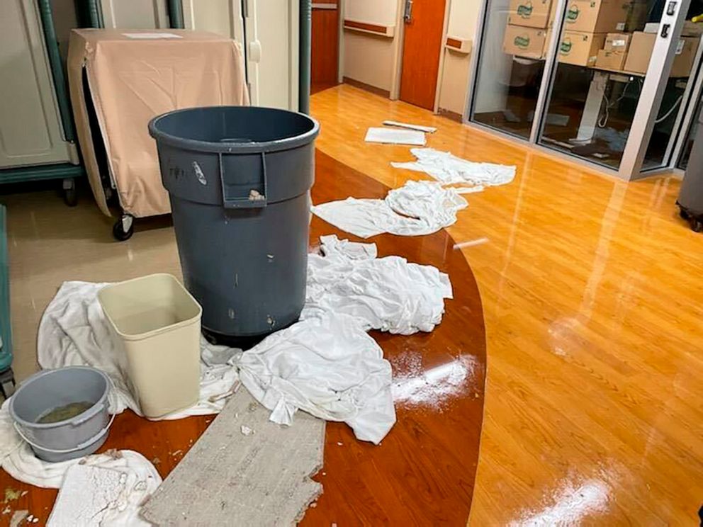 PHOTO: Various containers and clothes soak up floodwater near debris at an area at HCA Florida Fawcett Hospital in Port Charlotte, Fla., Sept. 28, 2022.