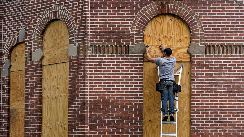 PHOTO: Workers board up the windows on the historical Henry B. Plant Hall on the campus of the University of Tampa ahead of Hurricane Ian, on Sept. 27, 2022, in Tampa, Fla.
