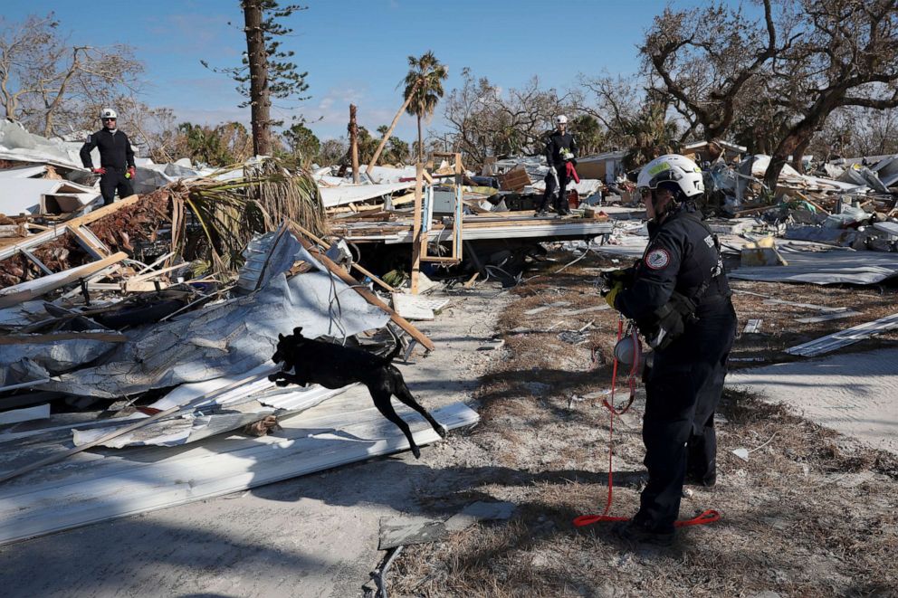 PHOTO: A search dog helps members of Virginia Task Force 2 Urban Search and Rescue comb through the wreckage looking for victims of Hurricane Ian, Oct. 4, 2022 in Fort Myers Beach, Florida.