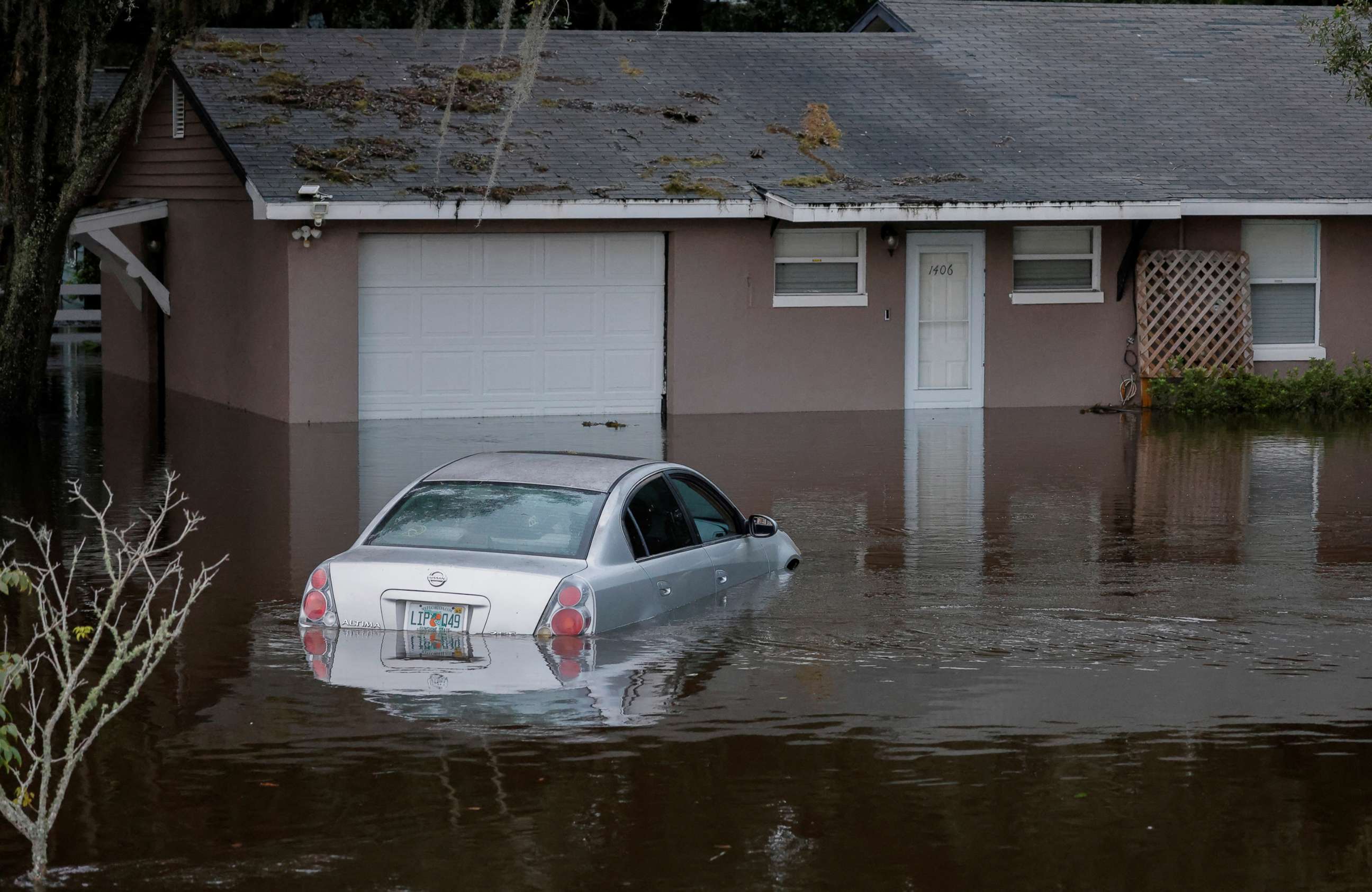 PHOTO: A partially submerged car and home are shown after Hurricane Ian caused widespread damage and flooding in Kissimmee, Fla., Sept. 29, 2022.