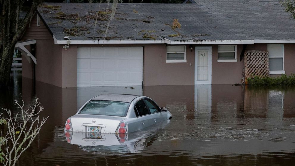 PHOTO: A partially submerged car and home are shown after Hurricane Ian caused widespread damage and flooding in Kissimmee, Fla., Sept. 29, 2022.