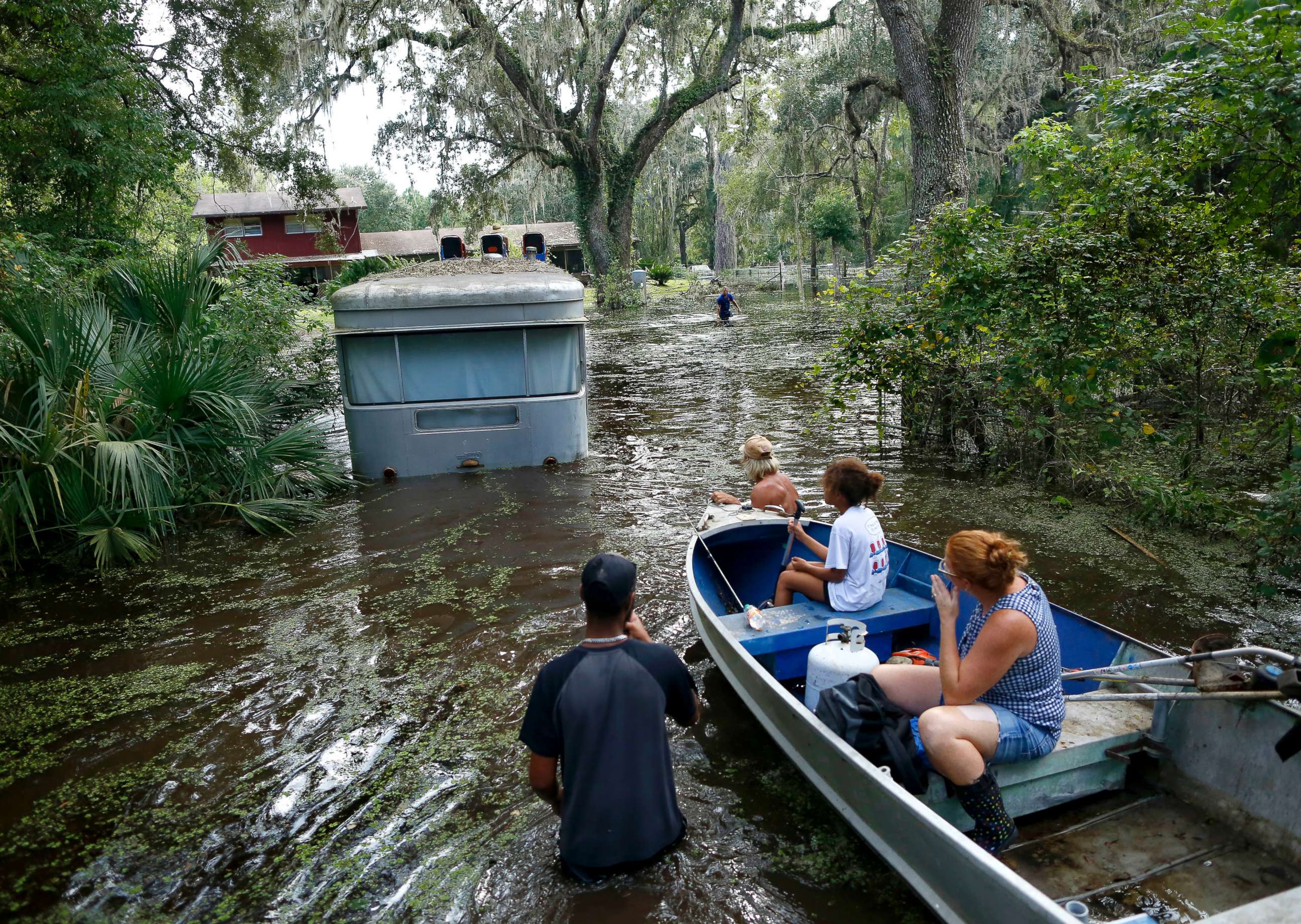 PHOTO: Family members ride in a small boat as Tony Holt's trailer is pulled out of the flood waters from Hurricane Irma in Gainesville, Fla., Sept. 14, 2017, after Hurricane Irma.