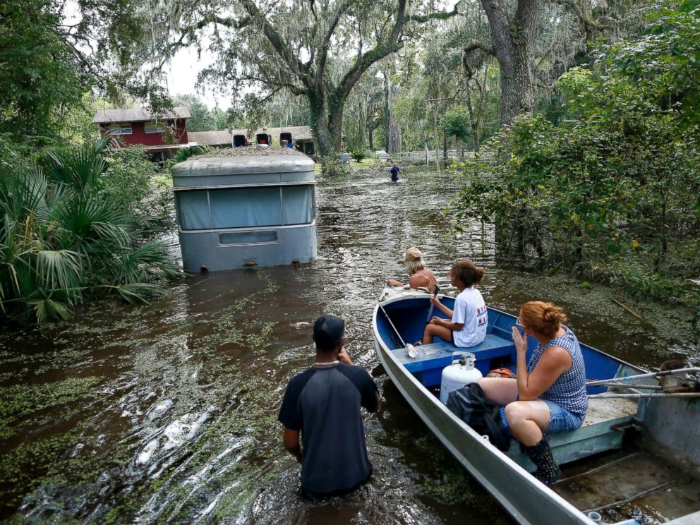 PHOTO: Family members ride in a small boat as Tony Holts trailer is pulled out of the flood waters from Hurricane Irma in Gainesville, Fla., Sept. 14, 2017, after Hurricane Irma.