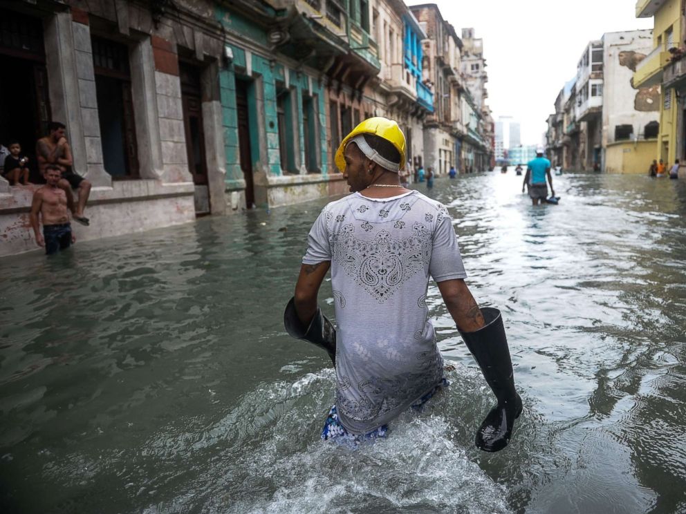 PHOTO: Cubans wade through a flooded street in Havana, Sept. 10, 2017.