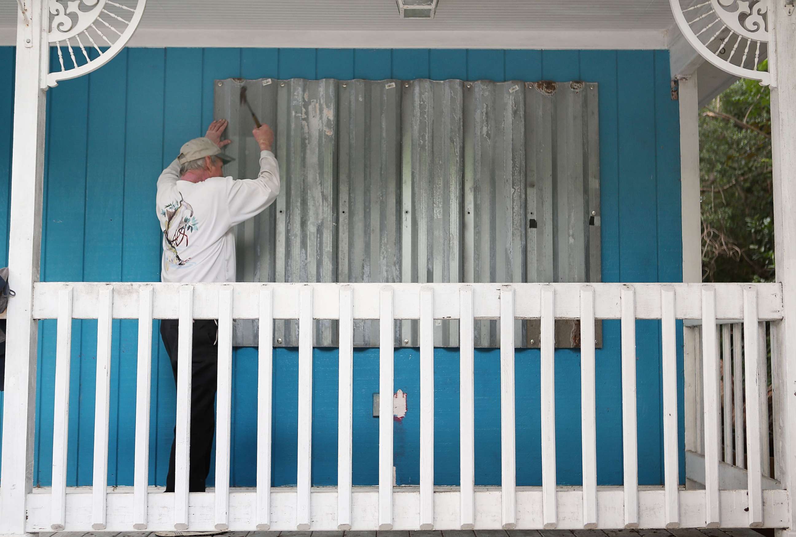 PHOTO: Mark Waddell installs hurricane shutters to a house in the Florida Keys, Sept. 6, 2017, in Islamorada, Fla. 