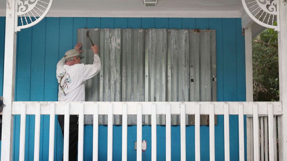 PHOTO: Mark Waddell installs hurricane shutters to a house in the Florida Keys, Sept. 6, 2017, in Islamorada, Fla. 
