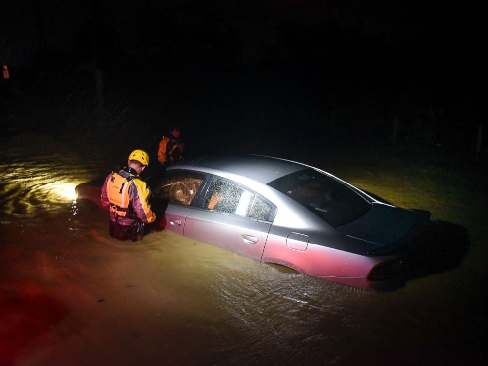 PHOTO: Rescue staff from the Municipal Emergency Management Agency investigate an empty flooded car during the passage of Hurricane Irma through the northeastern part of the island in Fajardo, Puerto Rico, Sept. 6, 2017.