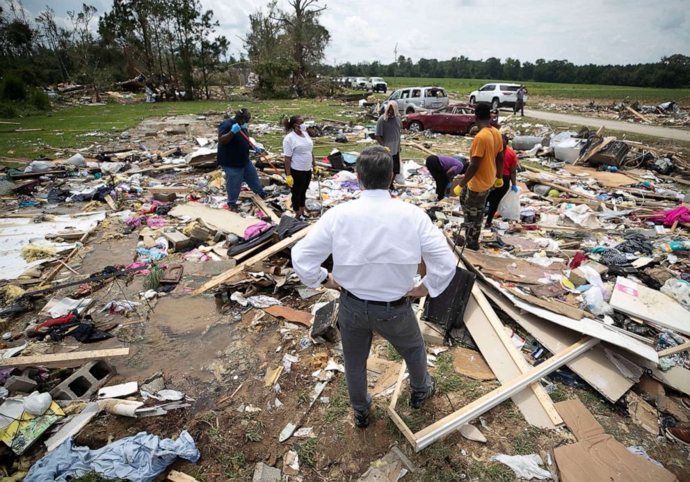 PHOTO: North Carolina Gov. Roy Cooper talks with residents, Aug. 5, 2020, as they looks for personal items in the rubble after a tornado spawned by Hurricane Isaias destroyed a rural mobile home neighborhood near Windsor, N.C.