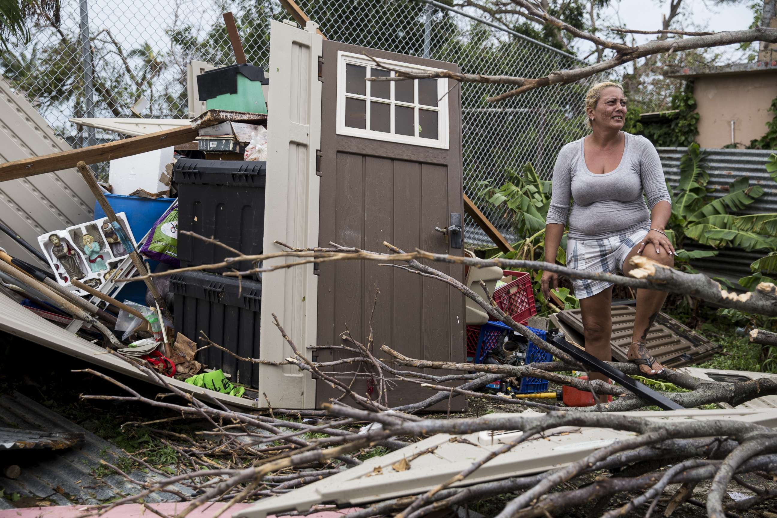 PHOTO: A resident surveys the damage on her property after Hurricane Maria made landfall, Sept. 21, 2017, in the Guaynabo suburb of San Juan, Puerto Rico.