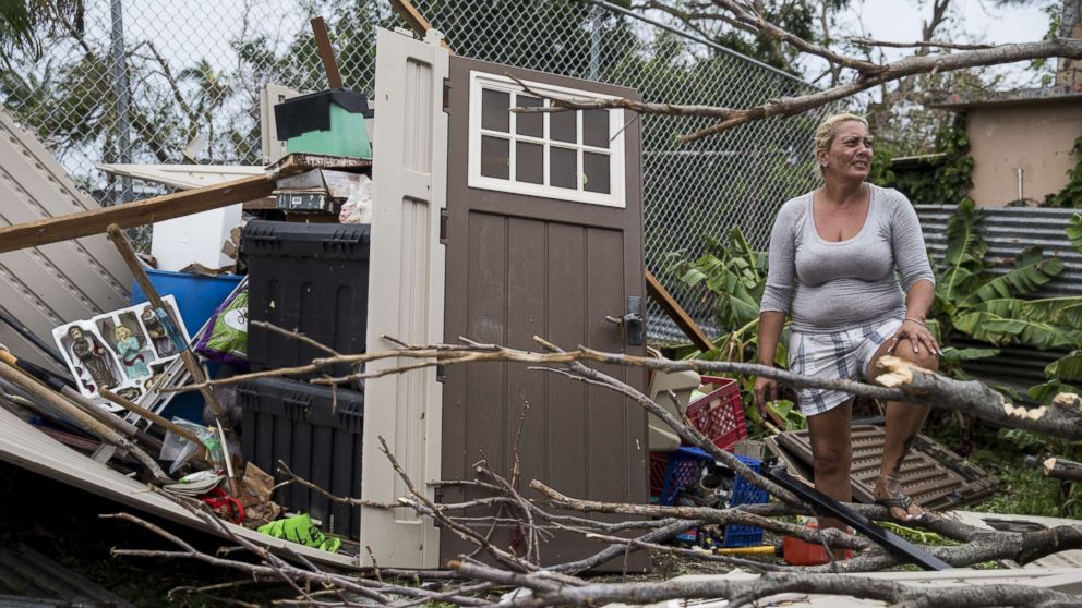PHOTO: A resident surveys the damage on her property after Hurricane Maria made landfall, Sept. 21, 2017, in the Guaynabo suburb of San Juan, Puerto Rico.