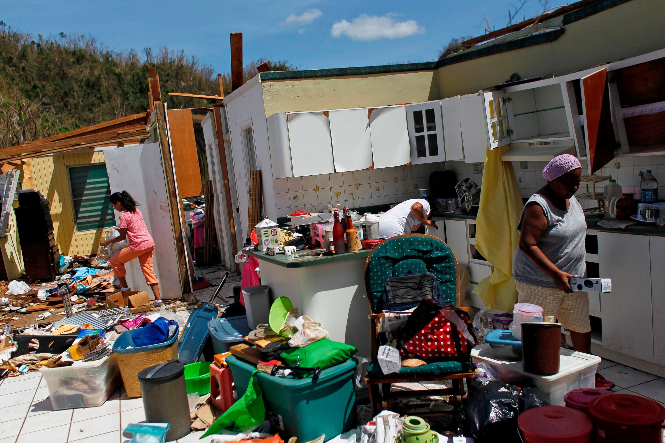 PHOTO: Family members collect belongings after hurricane force winds destroyed their house in Toa Baja, west of San Juan, Puerto Rico, on Sept. 24, 2017, following the passage of Hurricane Maria.