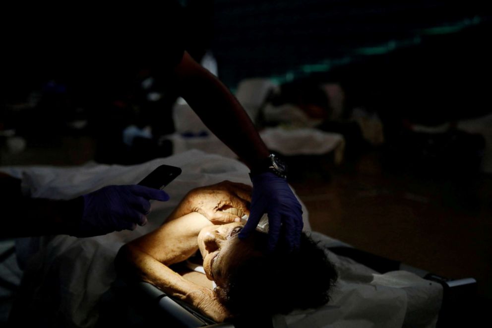 PHOTO: A doctor checks the eyes of Hilda Colon at a shelter set up at the Pedrin Zorrilla coliseum after the area was hit by Hurricane Maria in San Juan, Puerto Rico, Sept. 25, 2017.