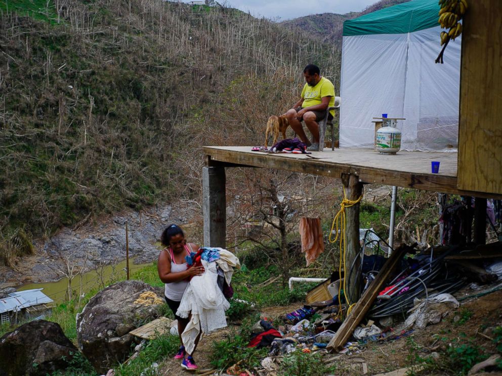 PHOTO: Yadira Sortre and William Fontan Quintero clean their house, destroyed by Hurricane Maria in in Morovis, Puerto Rico, Oct. 1, 2017.