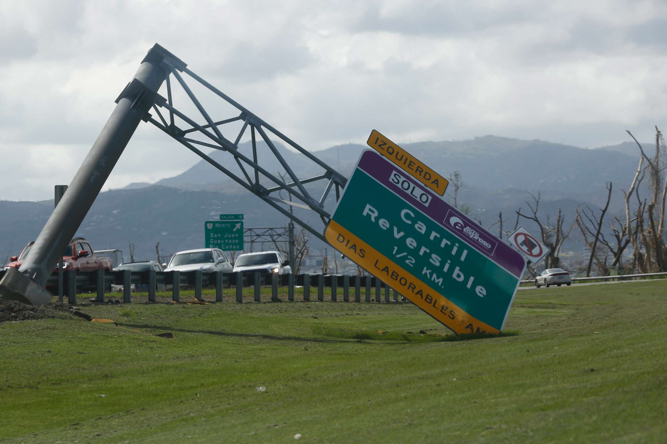 PHOTO: A street sign on the outskirts of San Juan toppled onto the median, in Guaynabo, Puerto Rico, Oct 2, 2017.