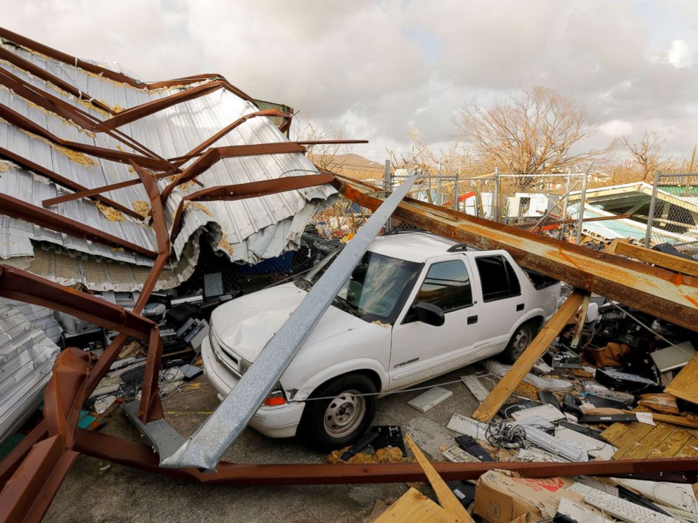 PHOTO: A car is seen crushed by steel beams and roofing that was mangled in the aftermath of Hurricane Maria at a recycling and waste management center in St. Croix, U.S. Virgin Islands, Sept. 27, 2017.