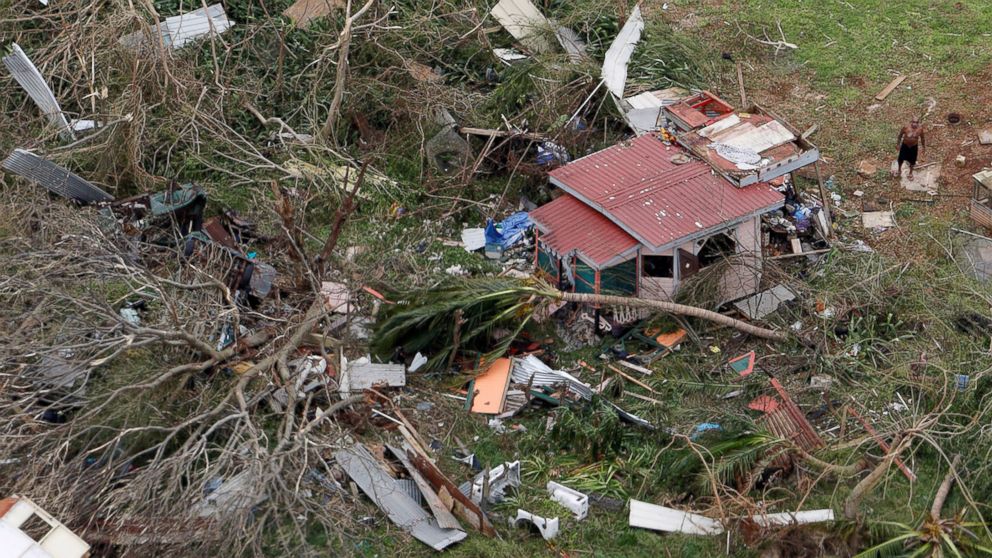 PHOTO: A man stands outside a destroyed home in this aerial photo from a Marine Corps MV-22 Osprey surveying the aftermath from Hurricane Maria in St. Croix, U.S. Virgin Islands, Sept. 21, 2017. 