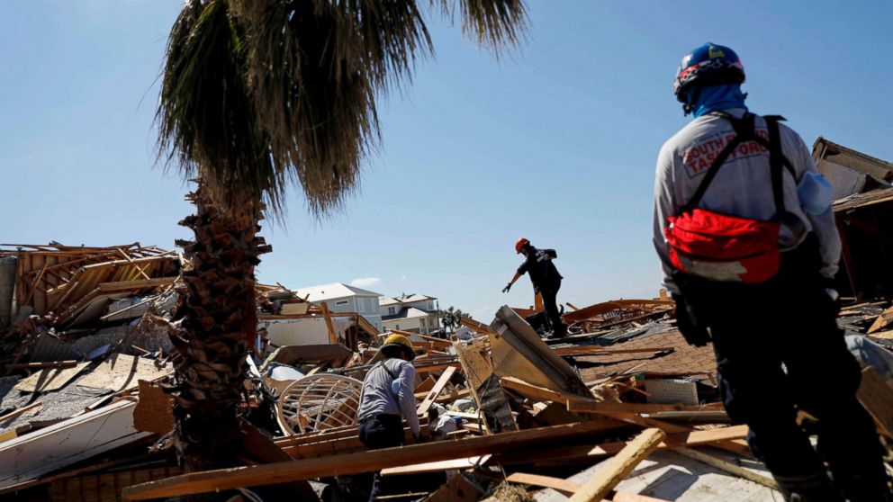 PHOTO: Members of a South Florida urban search and rescue team sift through a debris pile for survivors of Hurricane Michael in Mexico Beach, Fla., Oct. 14, 2018.