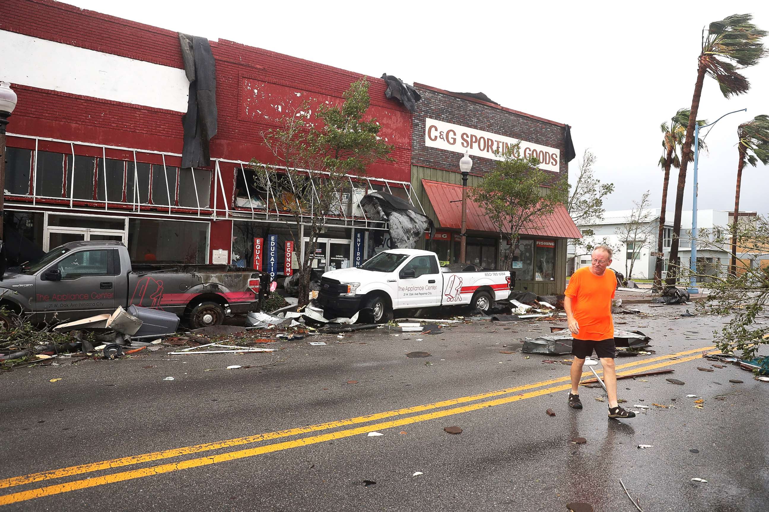 PHOTO: A man walks past damaged stores after hurricane Michael passed through the downtown area on Oct.10, 2018, in Panama City, Fla.