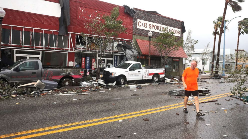 PHOTO: A man walks past damaged stores after hurricane Michael passed through the downtown area on Oct.10, 2018, in Panama City, Fla.