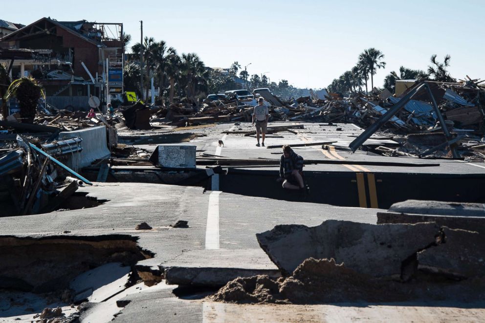 PHOTO: Local residents make their way across a washed out road after category 4 Hurricane Michael made land fall along the Florida panhandle, Oct. 12, 2018 in Mexico Beach, Fla.