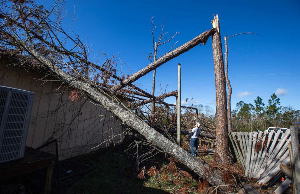 PHOTO: Ten days before Christmas and more than two months after Hurricane Michael made landfall, a resident stands outside his home that was hit by a snapped power pole in Panama City Beach, Fla., Dec. 15, 2018.