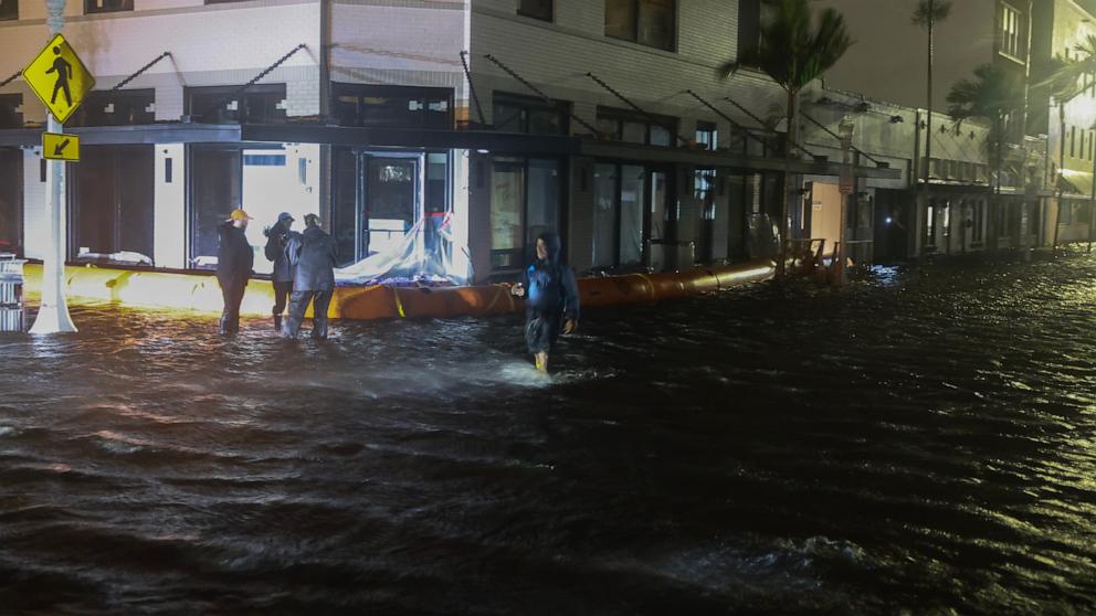 PHOTO: Members of the media work in flooded streets after Hurricane Milton made landfall in the Sarasota area on Oct. 9, 2024, in Fort Myers, Fla.