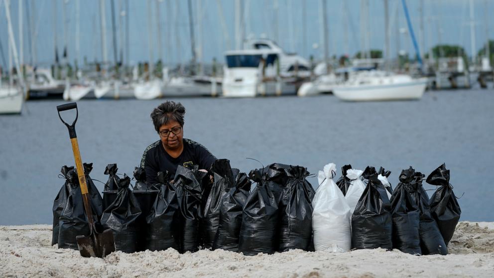 PHOTO: Susana Ortiz fills out sand bags on the beach at the Davis Islands Yacht Basin as she prepares for the arrival of Hurricane Milton, Oct. 8, 2024, in Tampa, Fla.