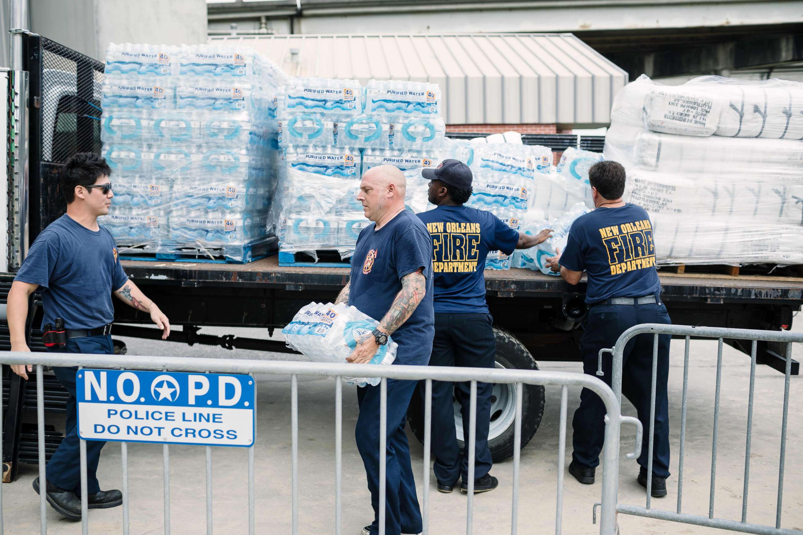 PHOTO: Firefighters Stan Ho (L) and Richard Jensen (C) unload supplies for the people of New Orleans in preparation of Hurricane Nate in New Orleans, Oct. 7, 2017.