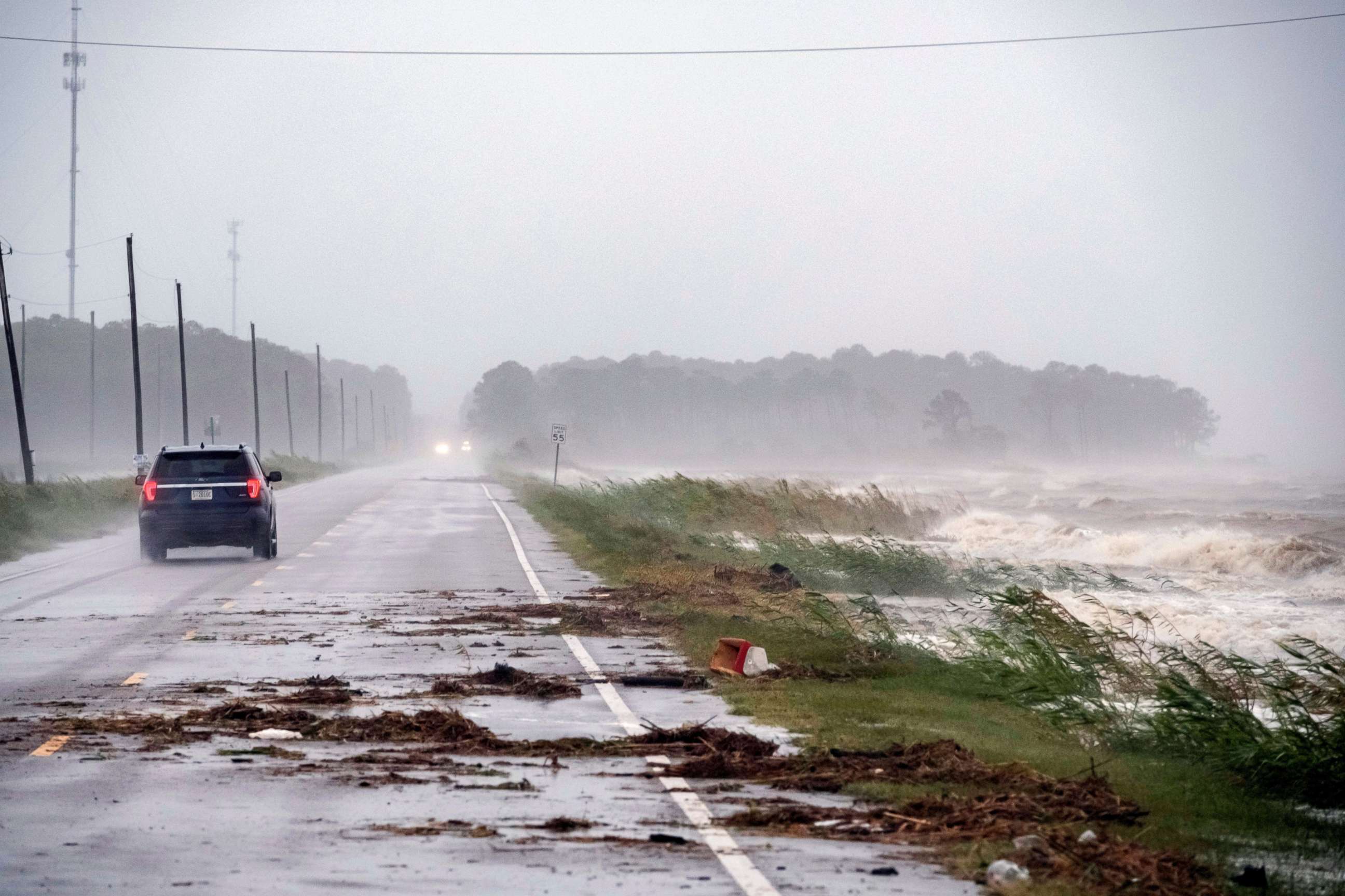 PHOTO: A car drives by crashing waves as Hurricane Sally approaches in Alabama Port, Alabama, Sept. 15, 2020.