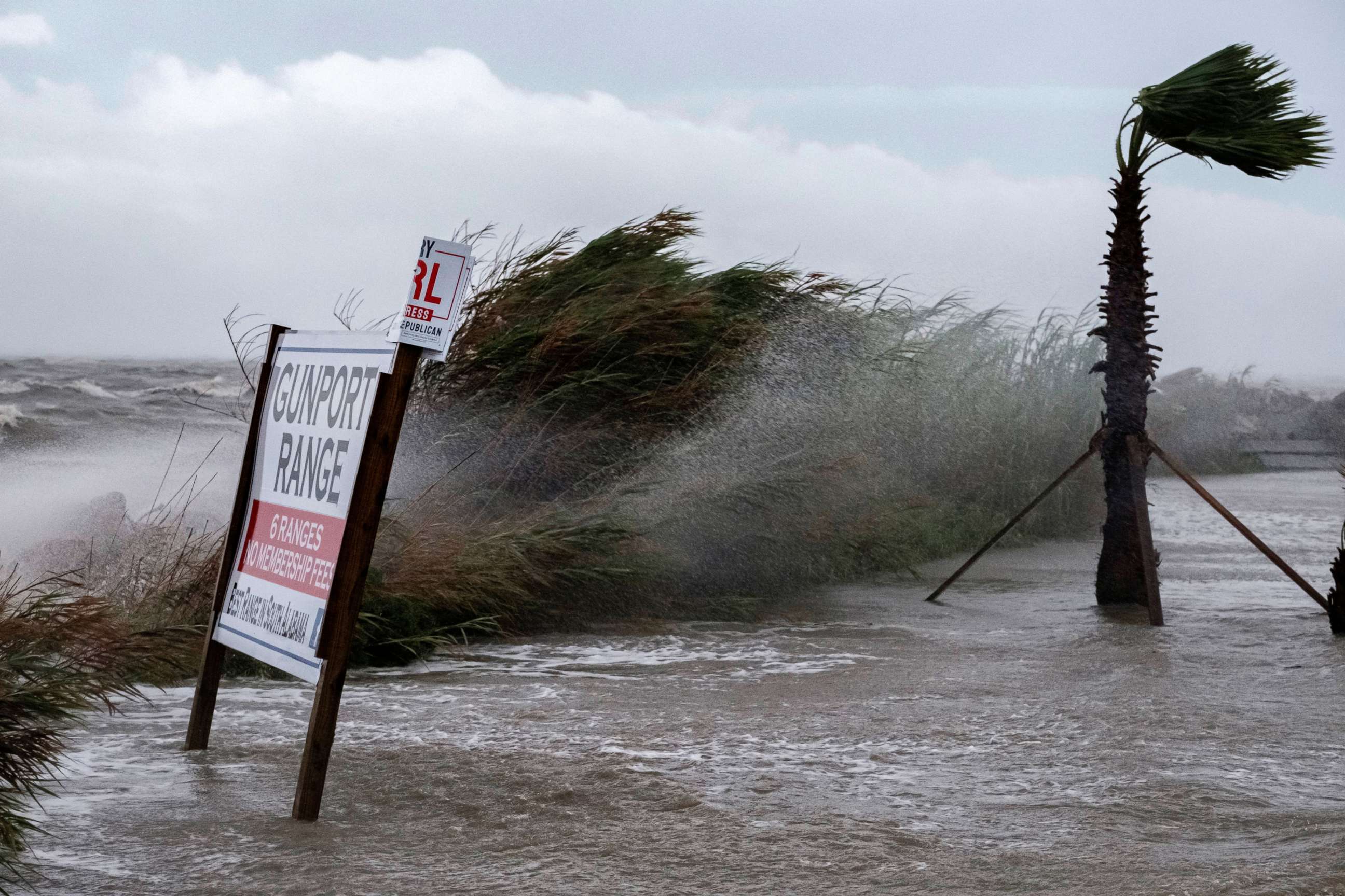 PHOTO: Water sprays on a  sign as water slowly covers a road from Hurricane Sally's approach in Alabama Port, Ala., Sept. 15, 2020.