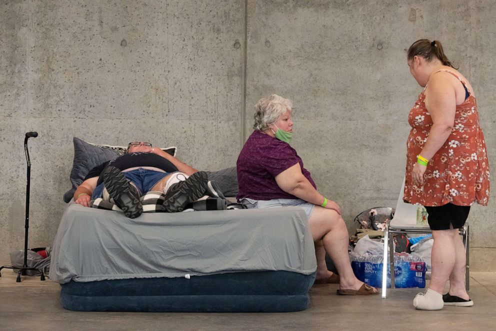 PHOTO: John Dixon, his wife Sabrina Young, and Erika Crain, talk about their experiences while at the Hancock County Evacuation Shelter in Kiln, Miss., in preparation for Hurricane Sally as it approaches the Gulf Coast, Sept. 14, 2020.