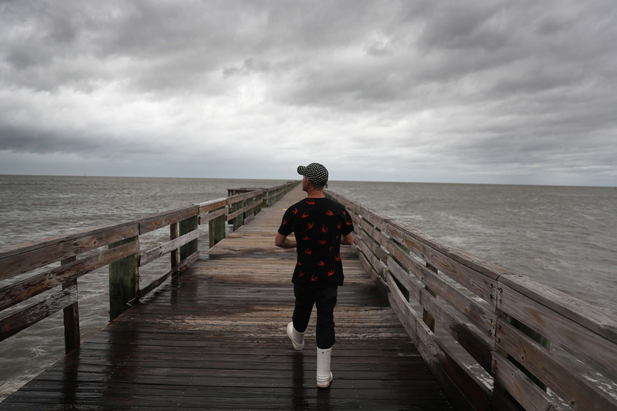 PHOTO: Bruce Laden walks along a pier to find a spot to fish from before the possible arrival of Hurricane Sally, Sept. 15, 2020, in Biloxi, Mississippi.