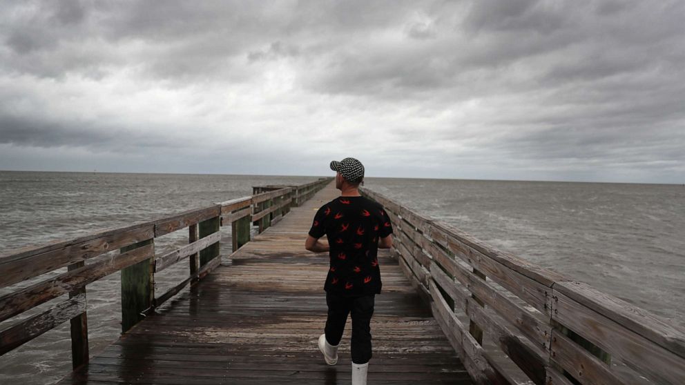 PHOTO: Bruce Laden walks along a pier to find a spot to fish from before the possible arrival of Hurricane Sally, Sept. 15, 2020, in Biloxi, Mississippi.