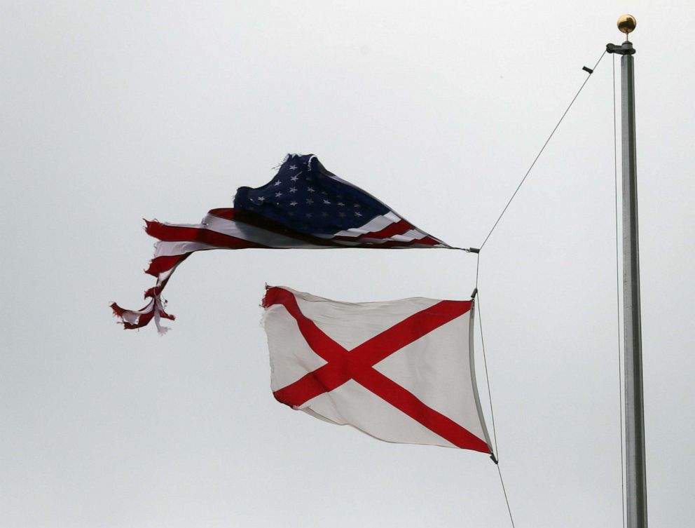 PHOTO: A tattered American flag is seen as the winds and rain from Hurricane Sally pass through the area on Sept. 16, 2020 in Mobile, Ala.