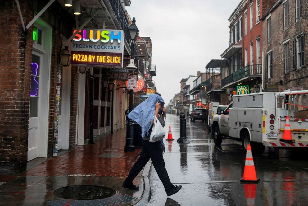 PHOTO: A man crosses a street as Hurricane Zeta approaches New Orleans, Oct. 28, 2020.