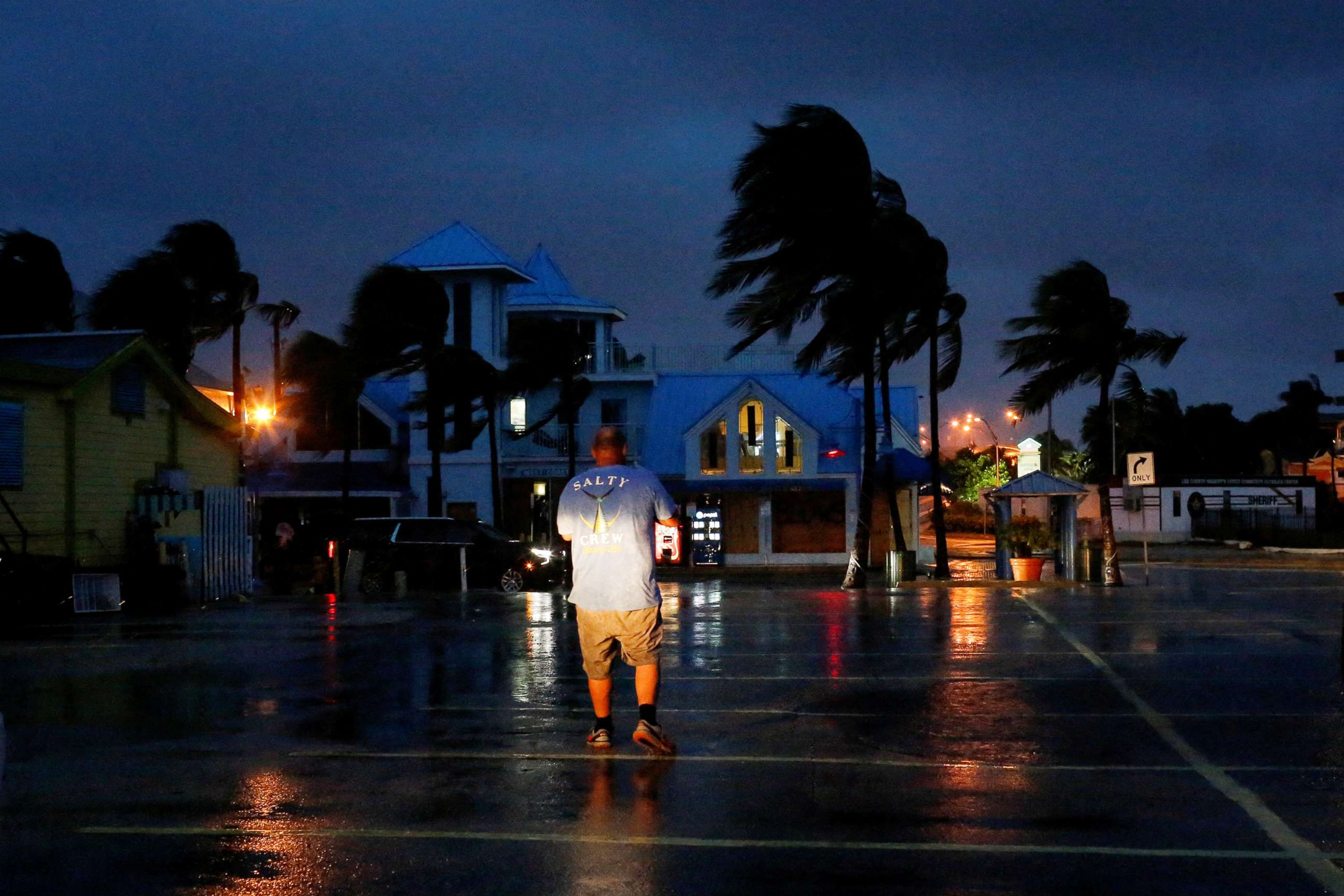 PHOTO: A man walks away from the beach ahead of Hurricane Ian, in Fort Myers, Fla., Sept. 28, 2022.