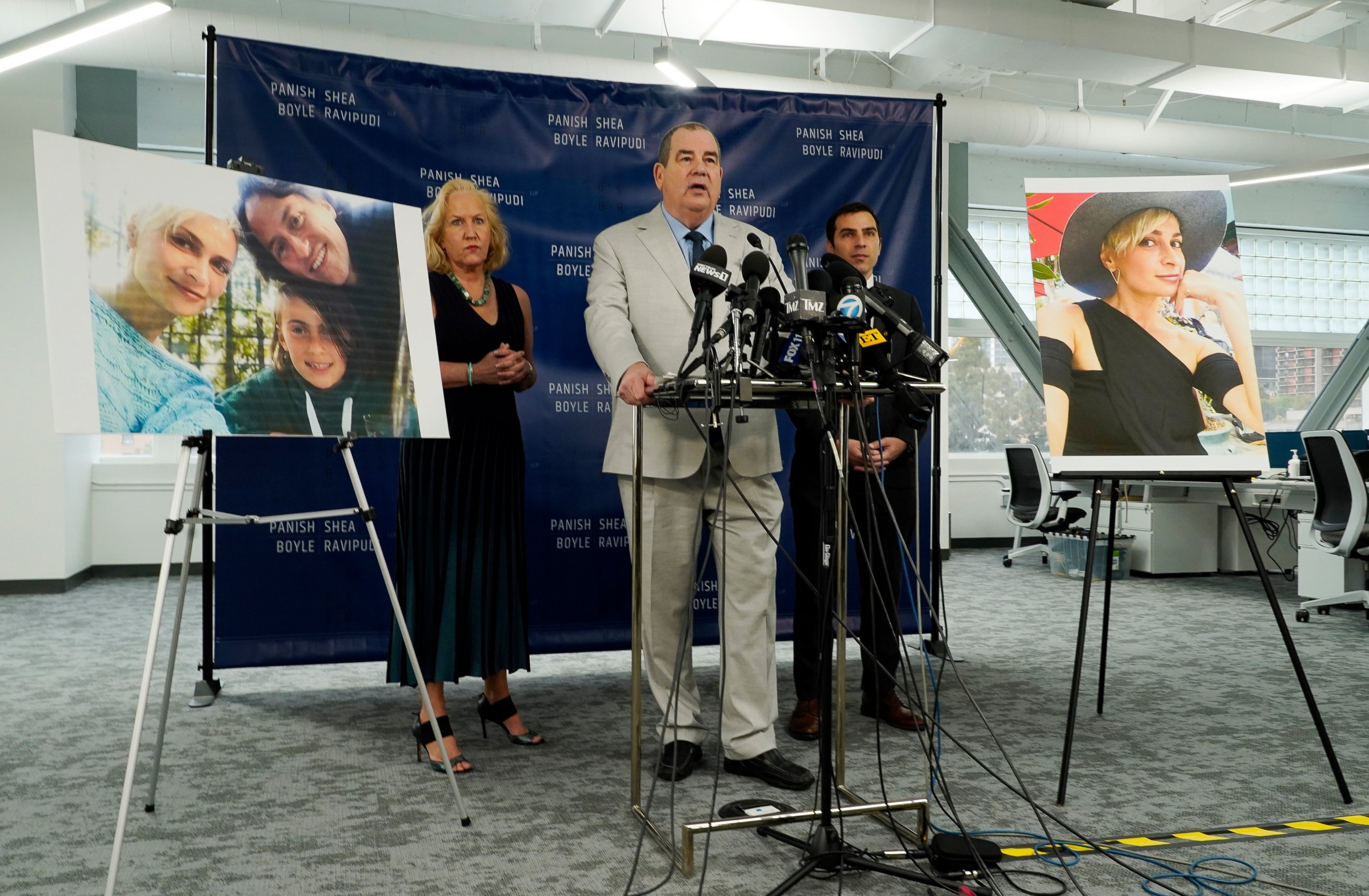 PHOTO: Randi McGinn, from left, Brian Panish and Jesse Creed, attorneys for the family of cinematographer Halyna Hutchins, take part in a news conference alongside portraits of Hutchins and her family, Feb. 15, 2022, in Los Angeles.
