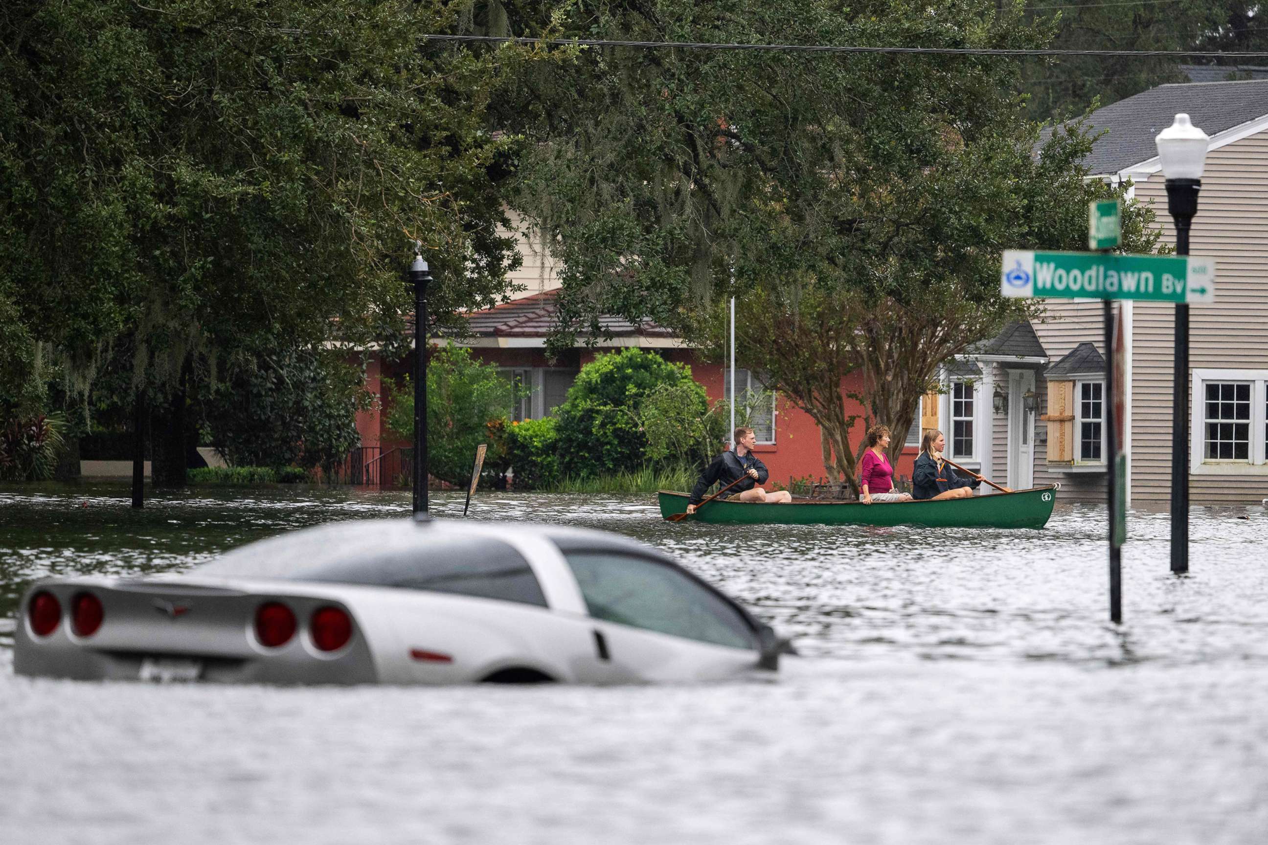 PHOTO: People paddle a canoe next to a submerged Chevy Corvette in the aftermath of Hurricane Ian in Orlando, Fla., Sept. 29, 2022. 