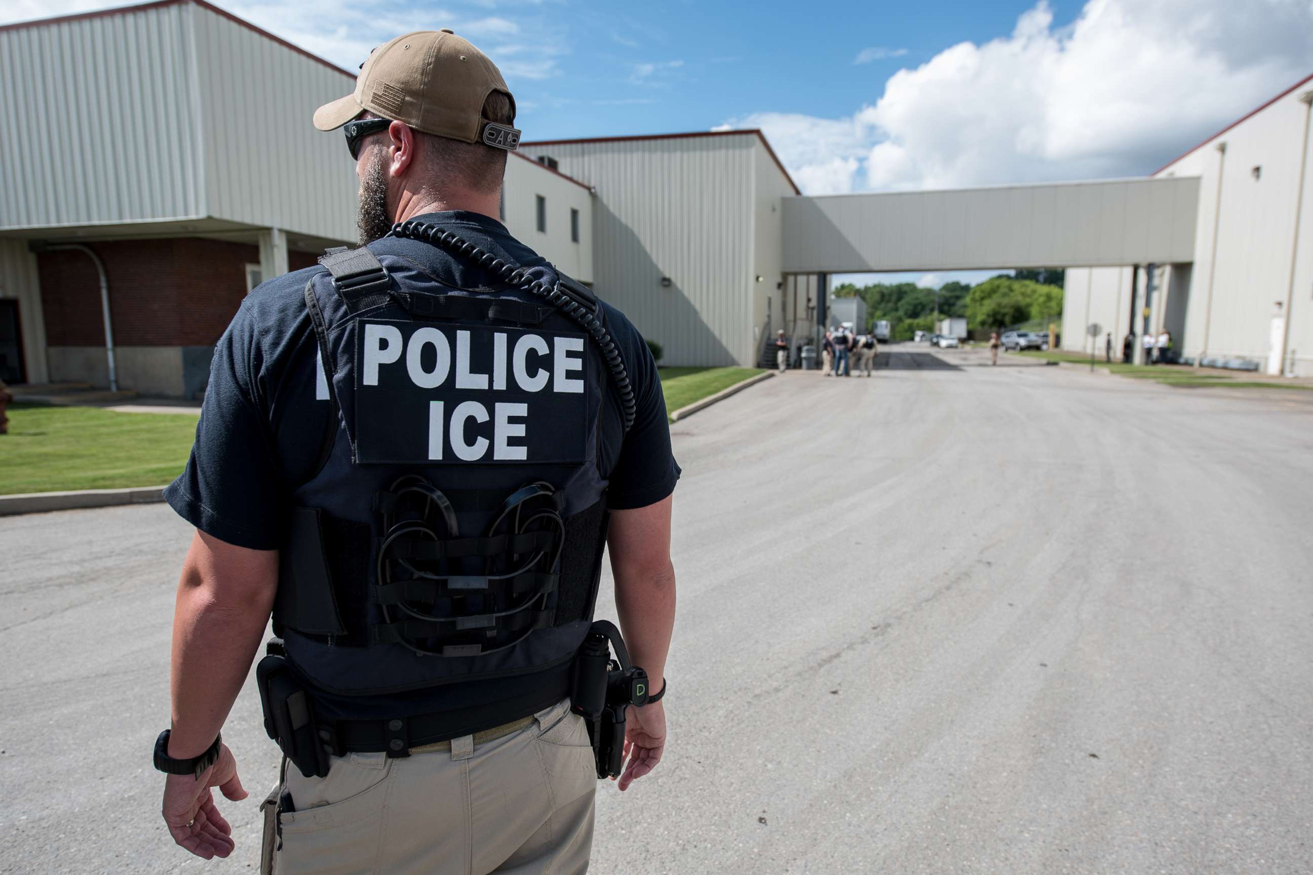 PHOTO: In this June 19, 2018, file photo, a US Immigration and Customs Enforcement (ICE) special agent prepares to arrest alleged immigration violators at Fresh Mark in Salem, Ohio.