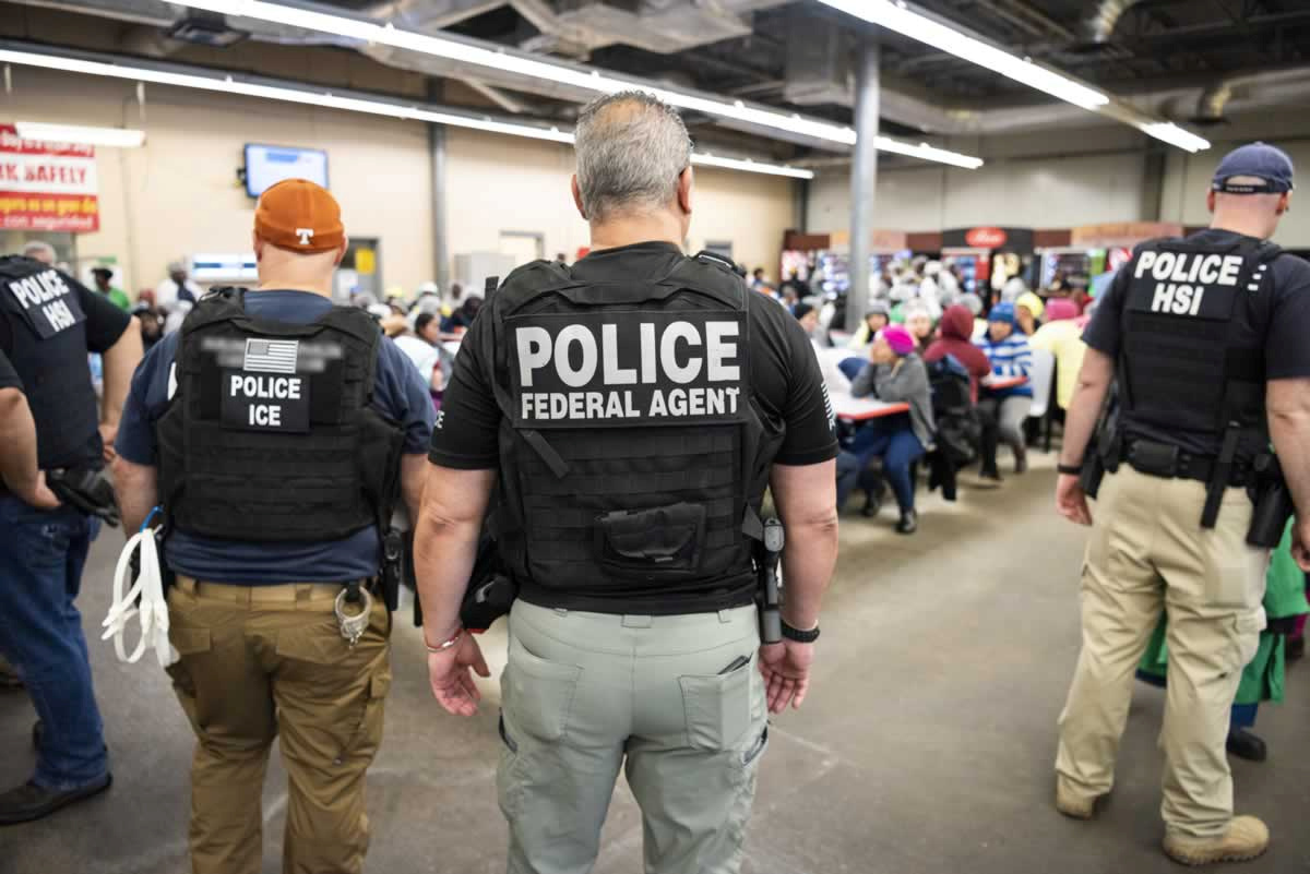 PHOTO: Officers from Immigration and Customs Enforcement look on after executing search warrants and making some arrests at an agricultural processing facility in Canton, Miss., in this photo released by ICE on Aug. 7, 2019.